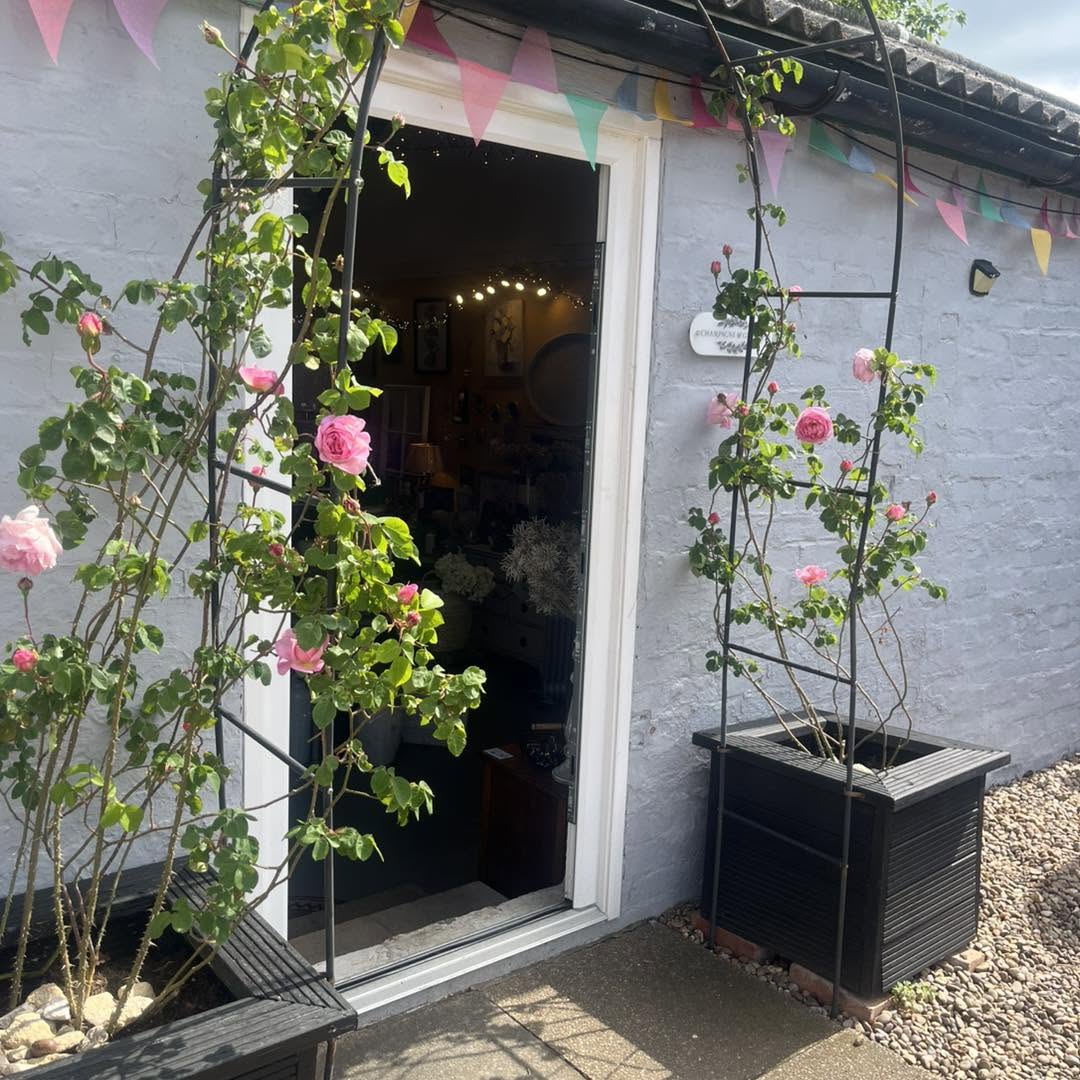 The shop's barn doors open onto a gravel forecourt
