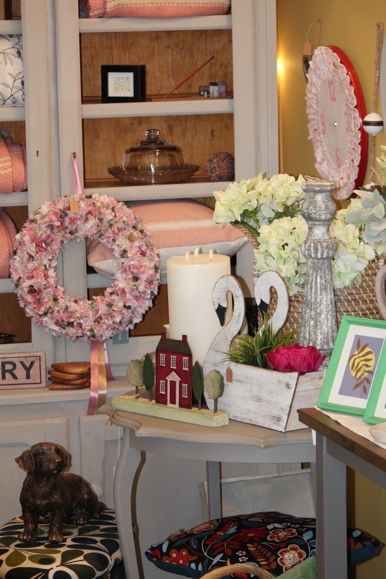 A rag wreath, candles and decorative pieces on display