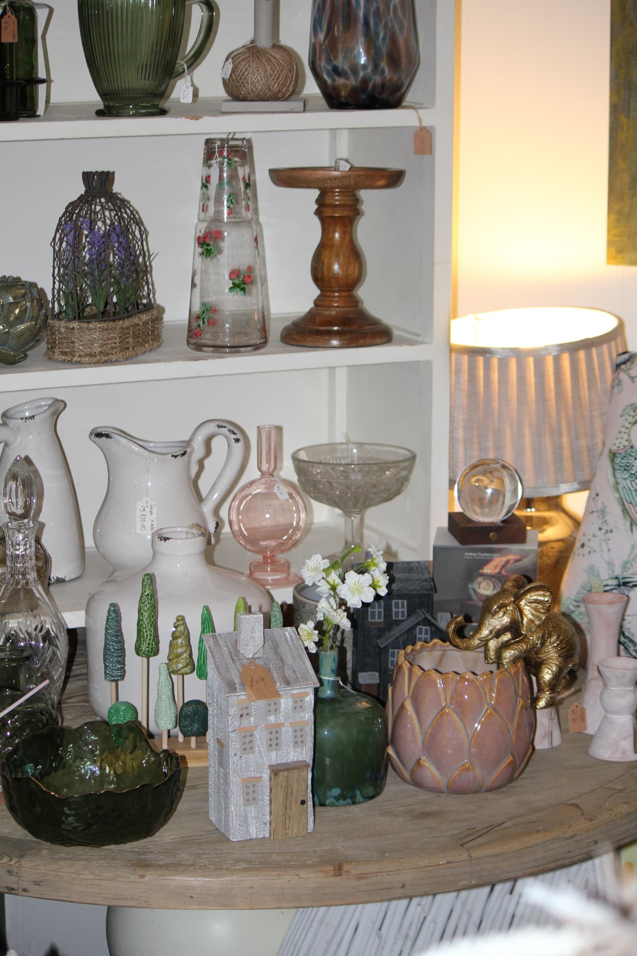 Shelves of glassware, jugs and ceramic planters