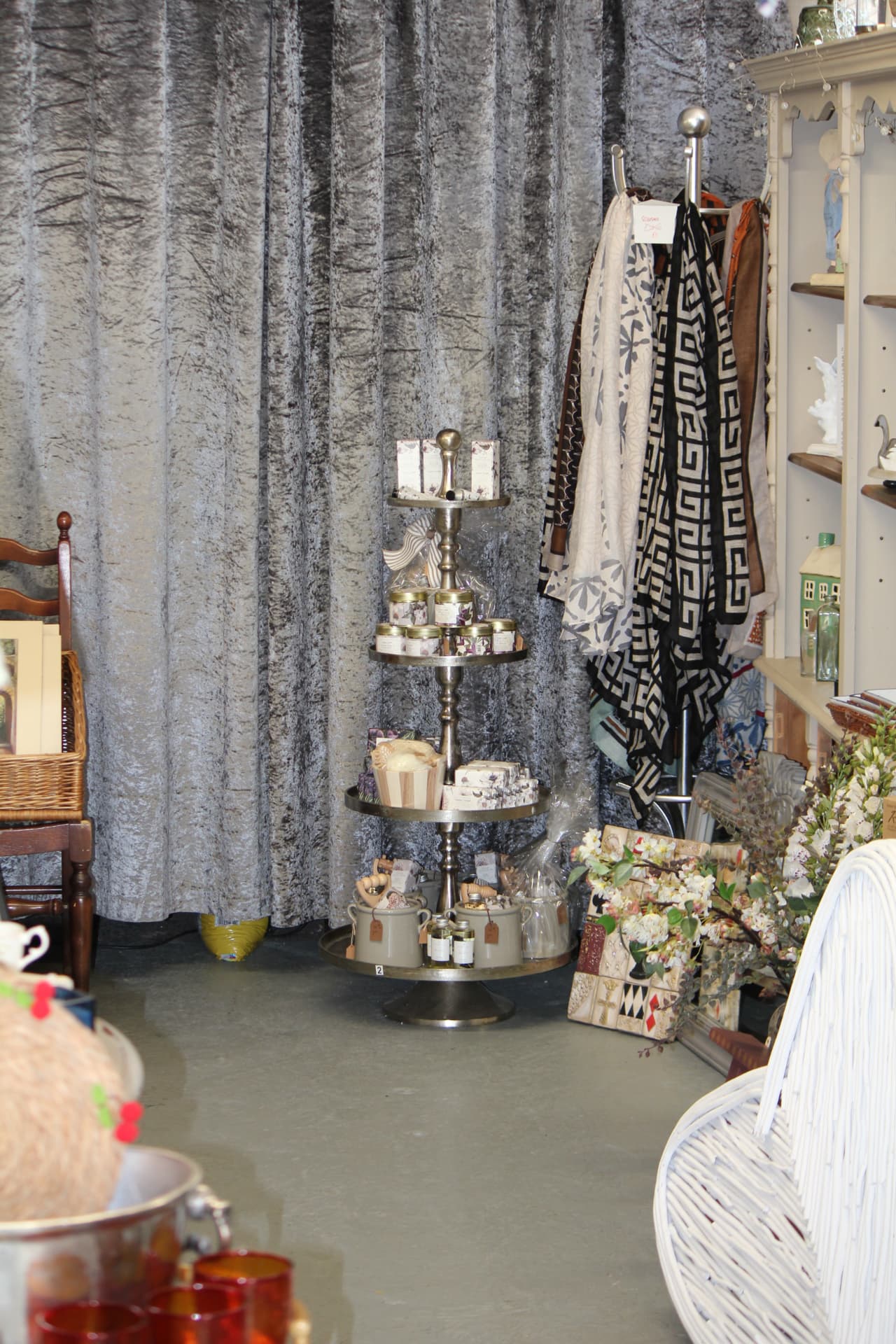 A tiered stand of candles, soaps and scarves in the shop