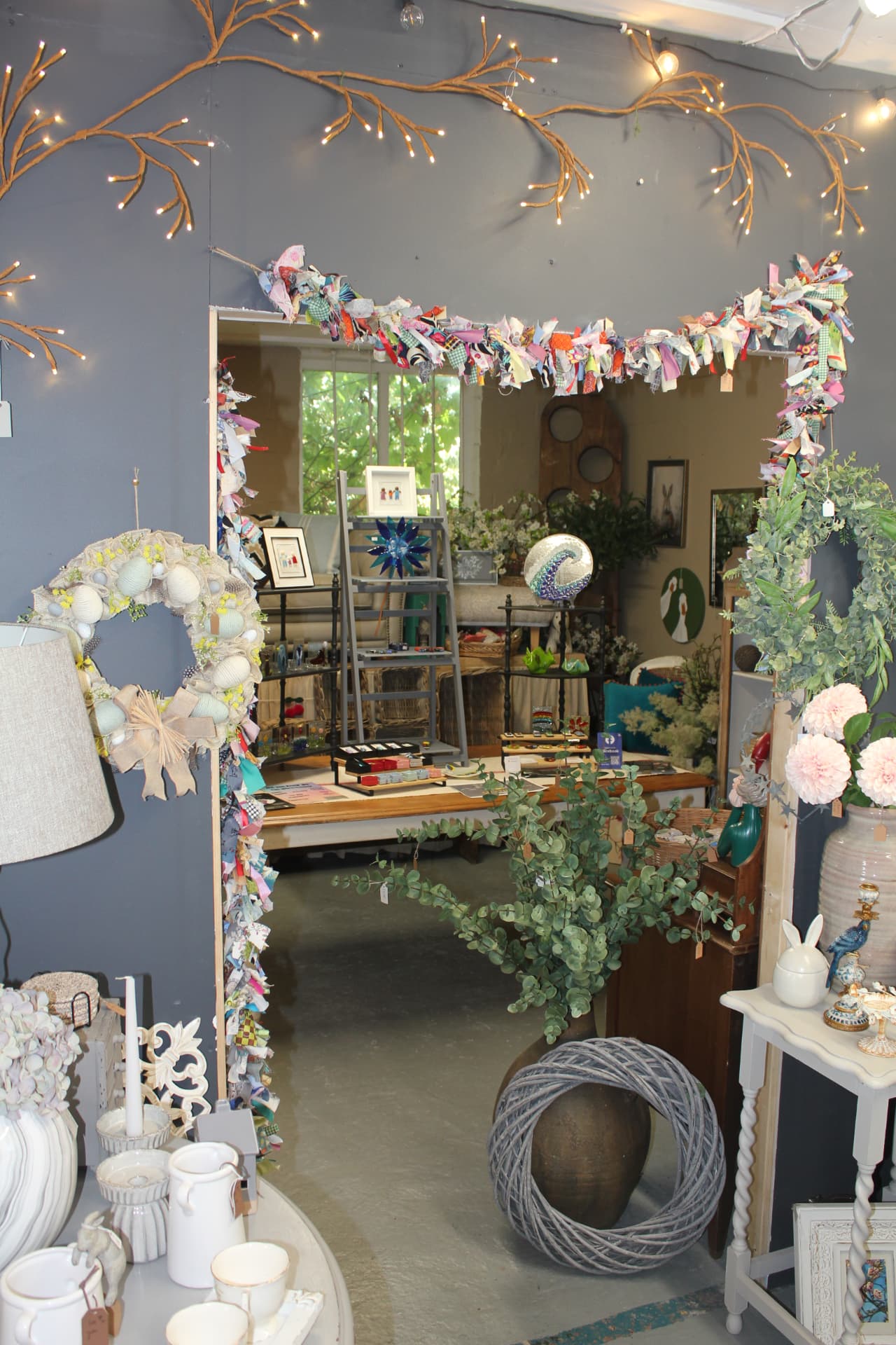 Looking through into the shop, dressed with rag garlands and fairy lights