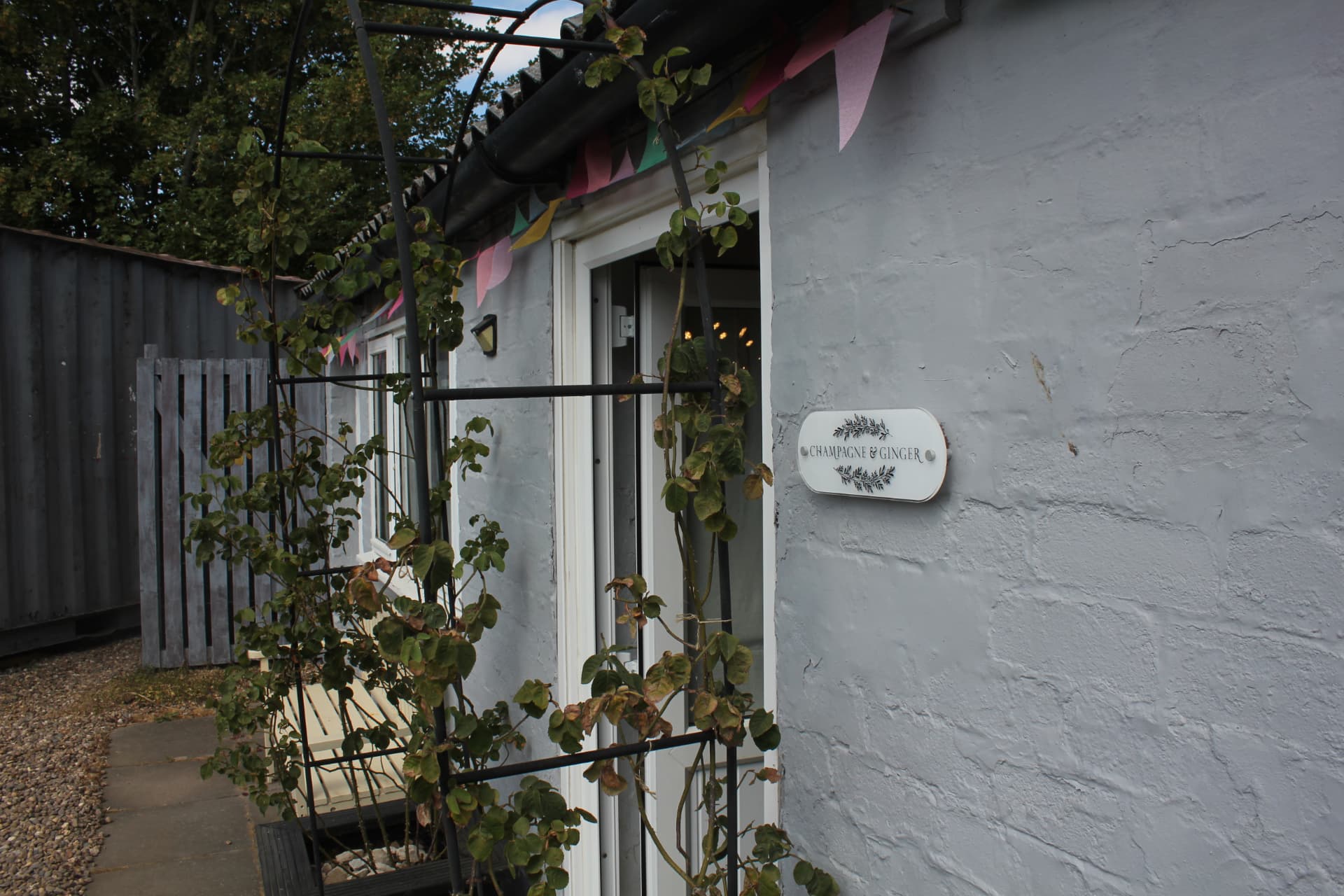 The Champagne & Ginger name plaque beside the shop door